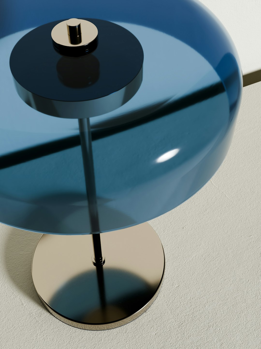 Minimalist modern table lamp with a sleek metallic base and a glossy blue dome-shaped shade.